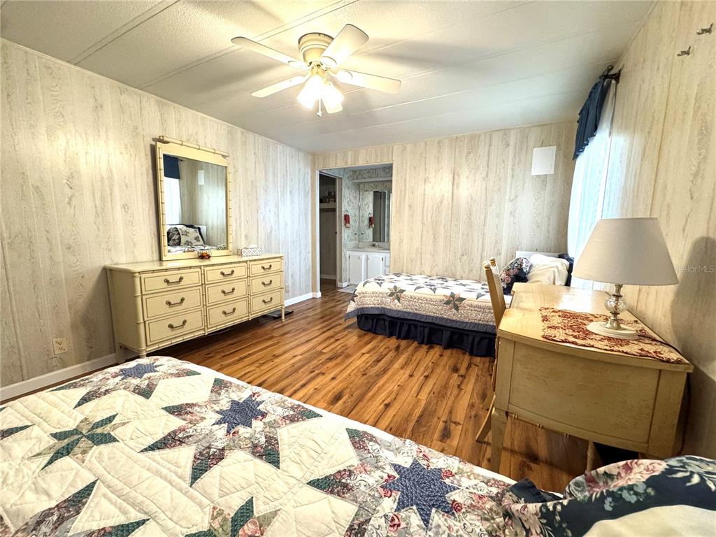 340 Peace Manor Palmetto, FL 34221 - Photo 25 of 38 a bedroom with a bed and wooden floor