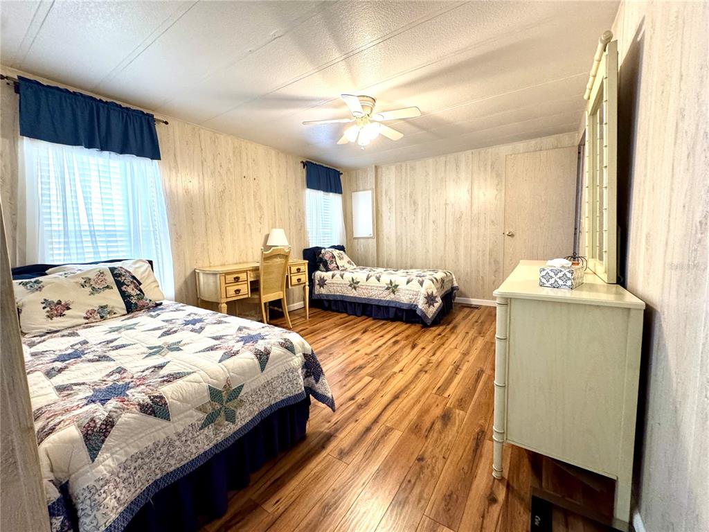 340 Peace Manor Palmetto, FL 34221 - Photo 27 of 38 a bedroom with a bed and a dresser with mirror