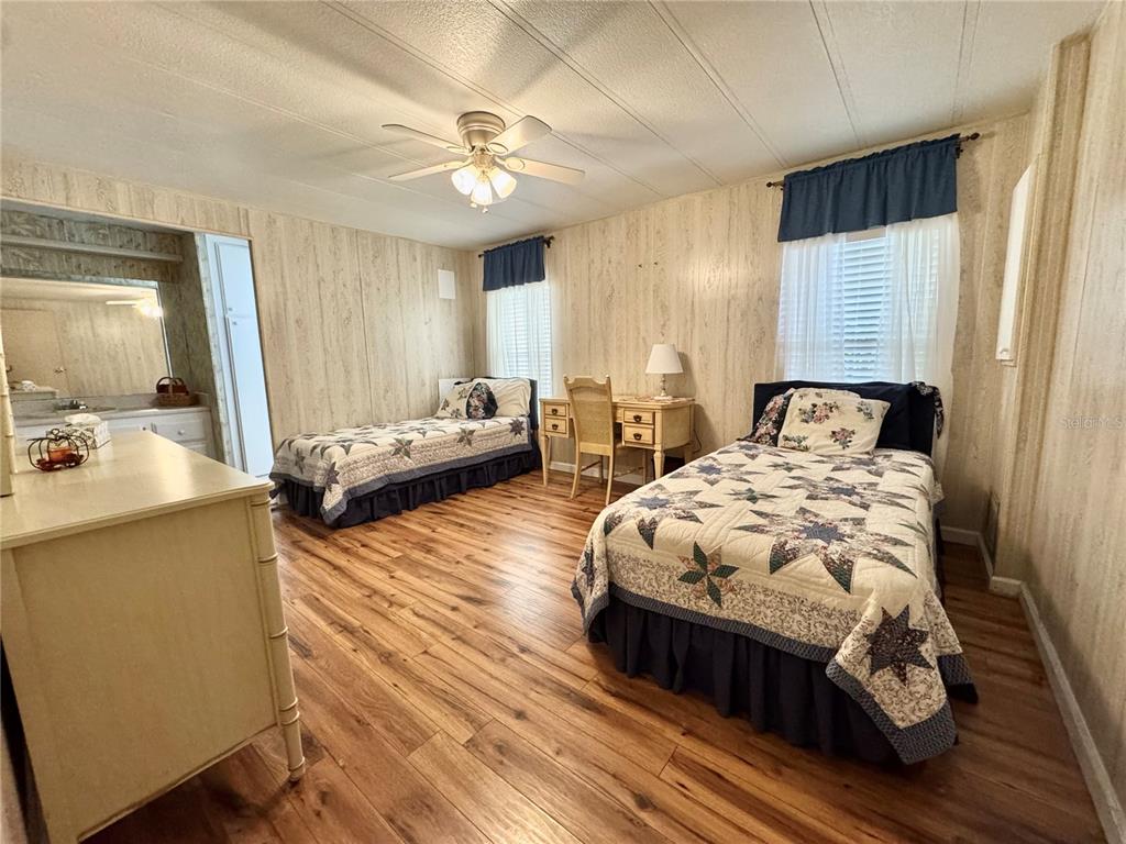 340 Peace Manor Palmetto, FL 34221 - Photo 28 of 38 a bedroom with a bed and wooden floor
