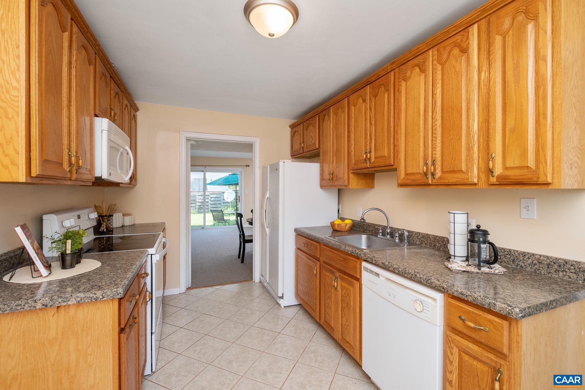 114 Georgetown Green Charlottesville, VA 22901 - Photo 13 of 44 a kitchen with a sink a stove and cabinets