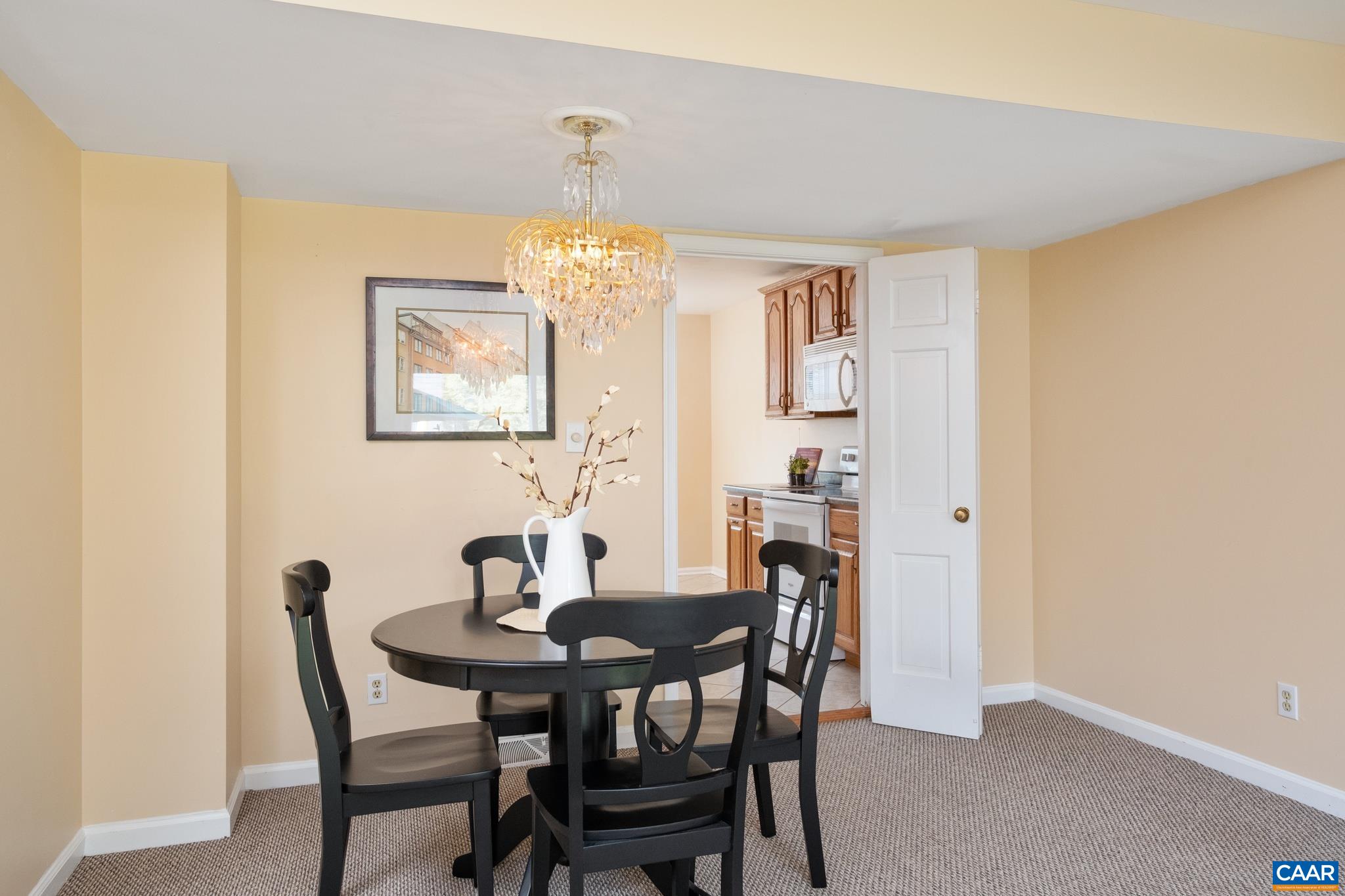 114 Georgetown Green Charlottesville, VA 22901 - Photo 15 of 44 a view of a dining room with furniture and chandelier