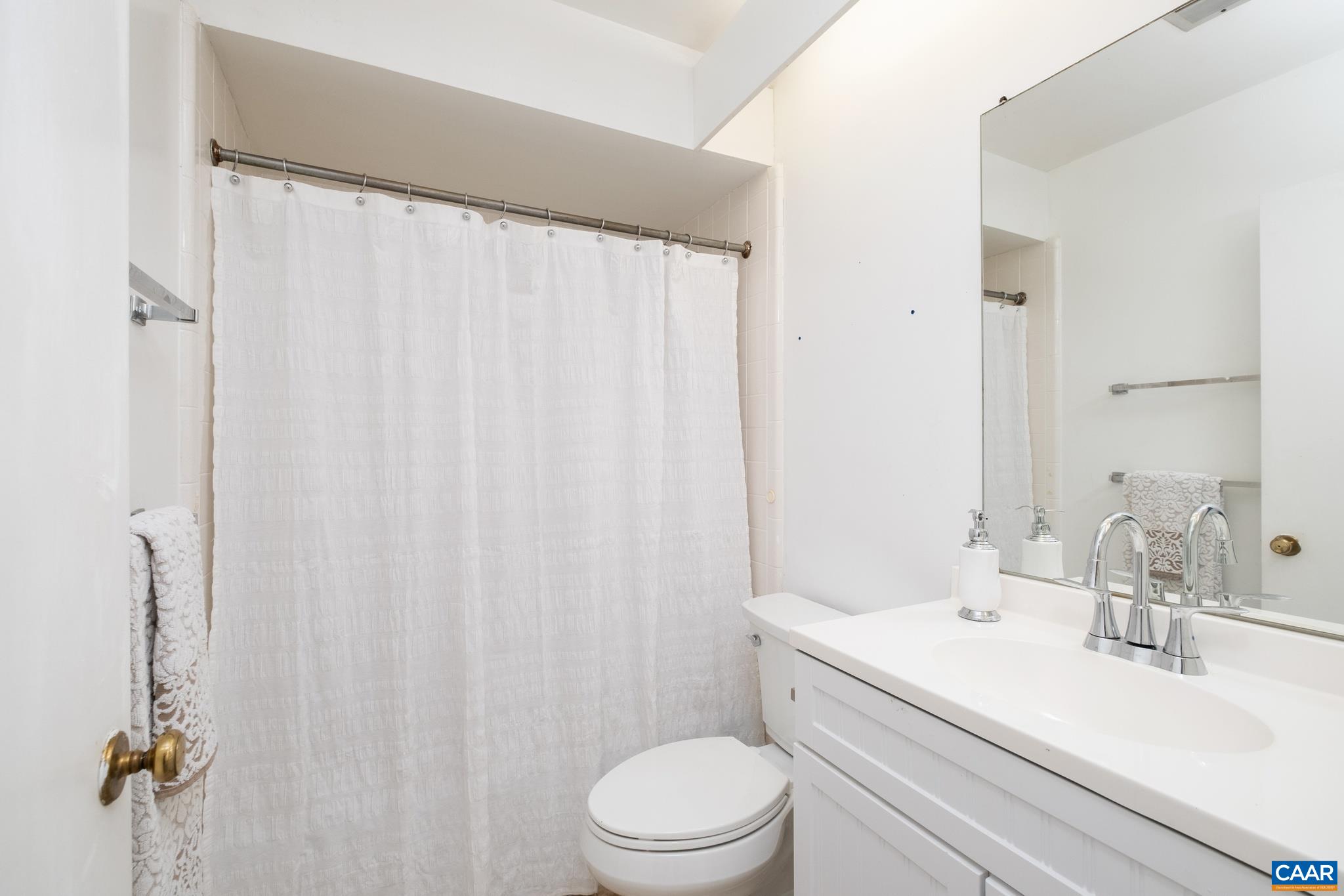 114 Georgetown Green Charlottesville, VA 22901 - Photo 29 of 44 a bathroom with a sink a toilet and shower curtain