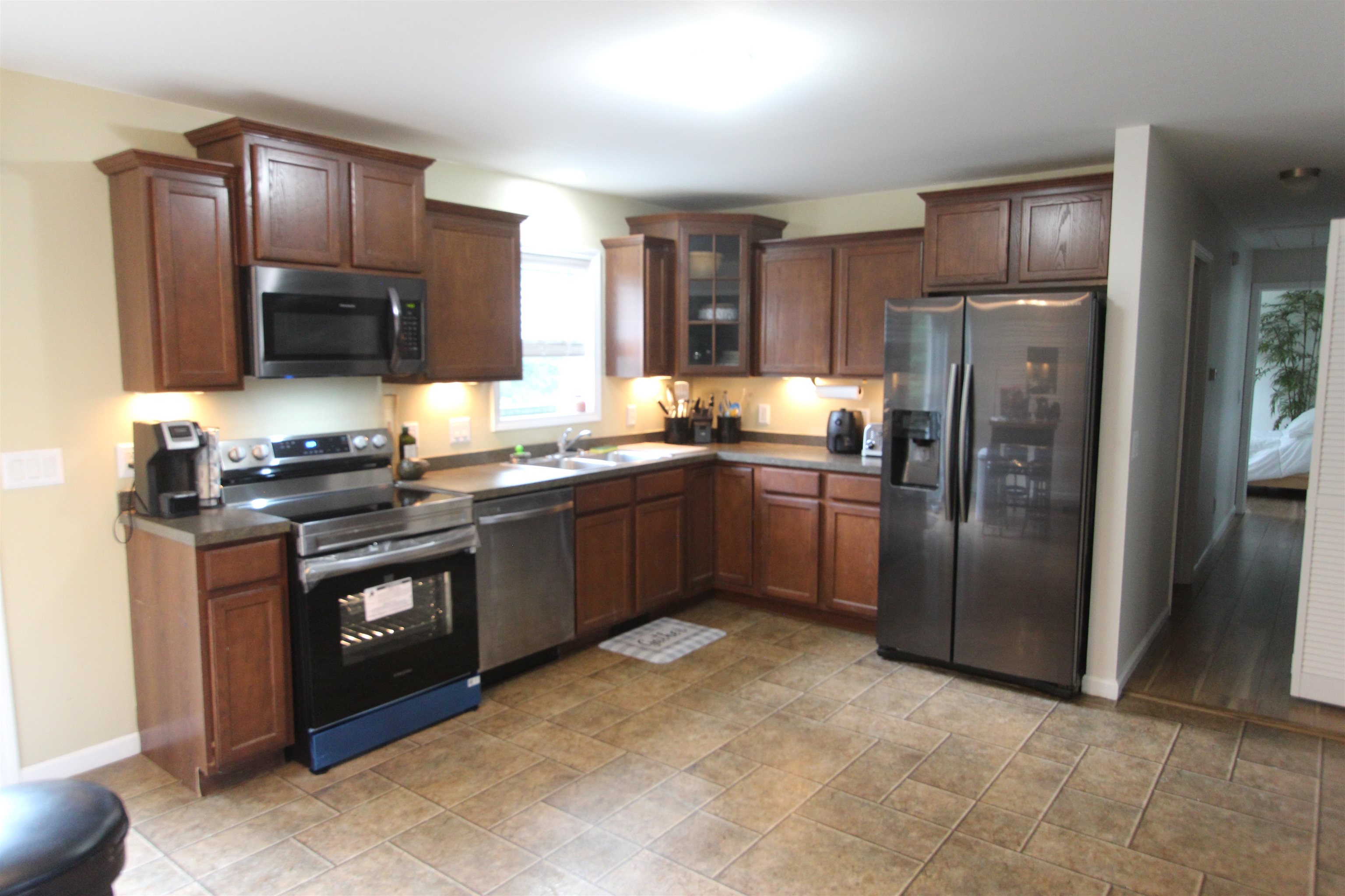 972 Tecumseh Road Erma, NJ 08204 - Photo 15 of 30 a kitchen with granite countertop stainless steel appliances and wooden cabinets