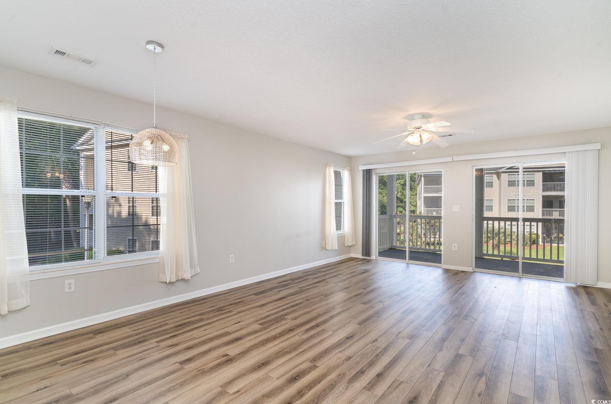 651 Woodmoor Drive, Unit 201 Murrells Inlet, SC 29576 - Photo 13 of 35 Spare room with wood finished floors and ceiling fan