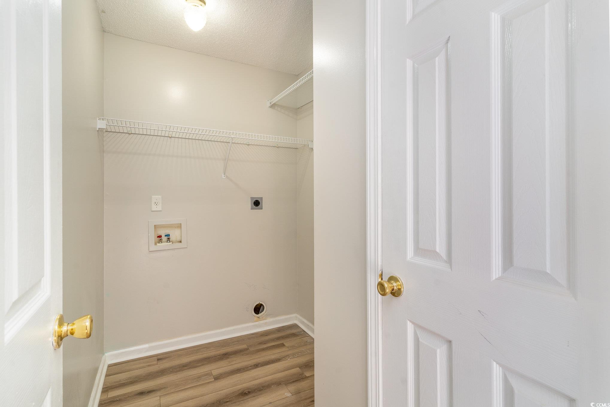 651 Woodmoor Drive, Unit 201 Murrells Inlet, SC 29576 - Photo 14 of 35 Laundry area featuring wood finished floors, a textured ceiling, electric dryer hookup, and hookup for a washing machine