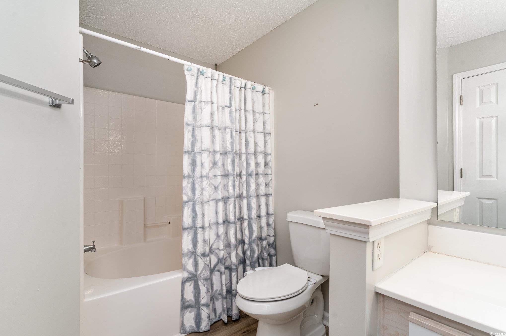 651 Woodmoor Drive, Unit 201 Murrells Inlet, SC 29576 - Photo 20 of 35 Full bathroom featuring shower / bath combo with shower curtain and vanity