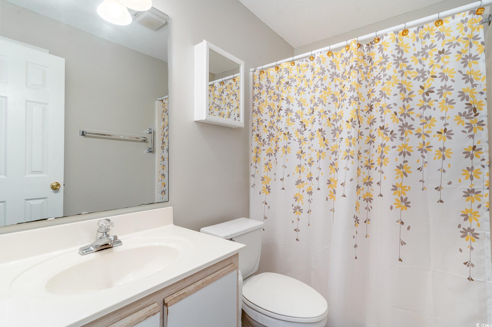 651 Woodmoor Drive, Unit 201 Murrells Inlet, SC 29576 - Photo 23 of 35 Bathroom featuring a shower with shower curtain and vanity