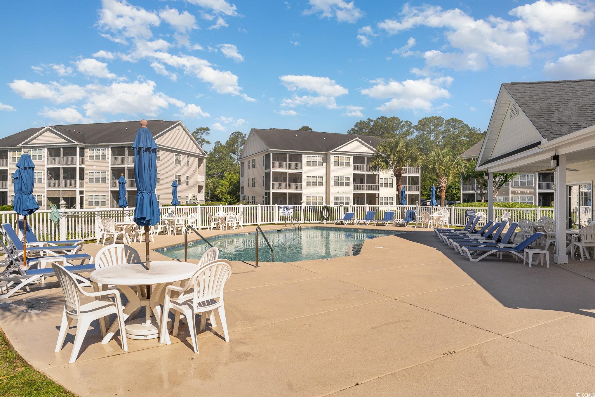 651 Woodmoor Drive, Unit 201 Murrells Inlet, SC 29576 - Photo 30 of 35 Community pool featuring a patio