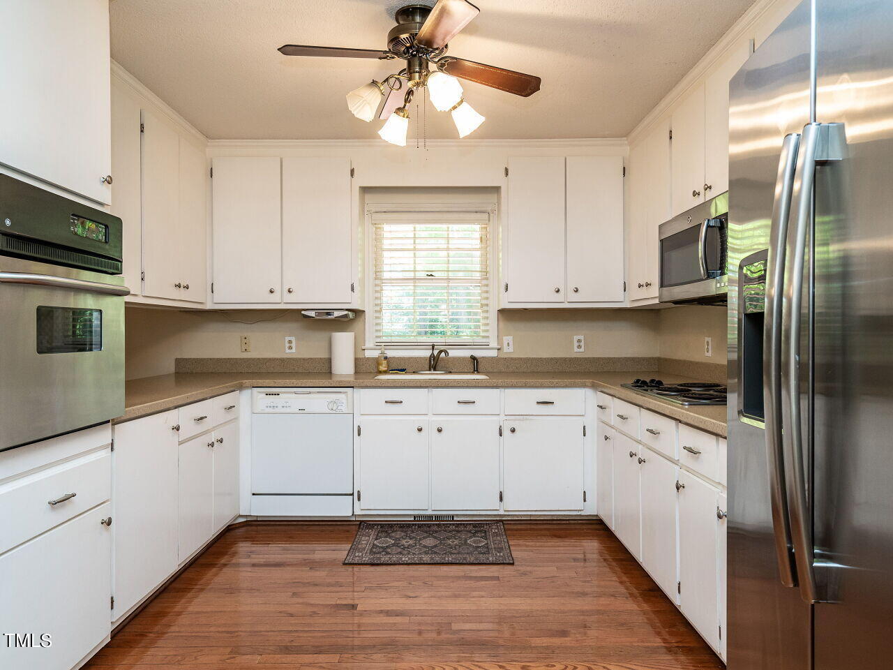 6600 Barbee Road Durham, NC 27713 - Photo 11 of 33 a kitchen with granite countertop white cabinets white stainless steel appliances with a sink and dishwasher