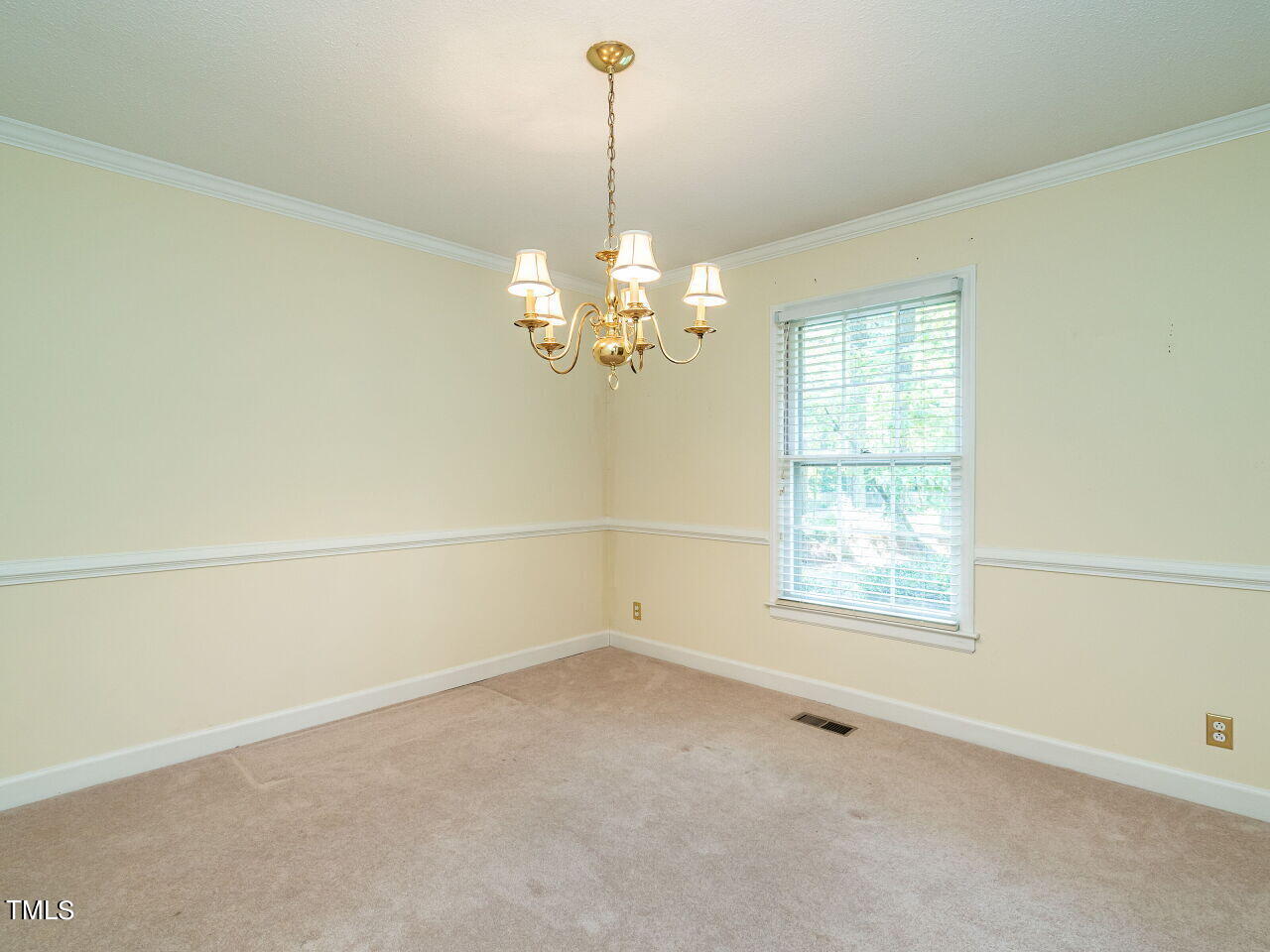 6600 Barbee Road Durham, NC 27713 - Photo 8 of 33 en empty room with windows and chandelier fan