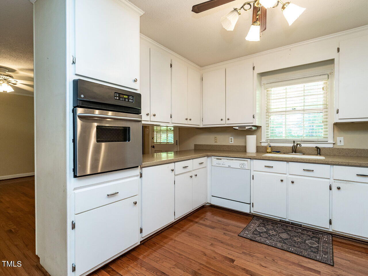 6600 Barbee Road Durham, NC 27713 - Photo 10 of 33 a kitchen with granite countertop white cabinets and white appliances