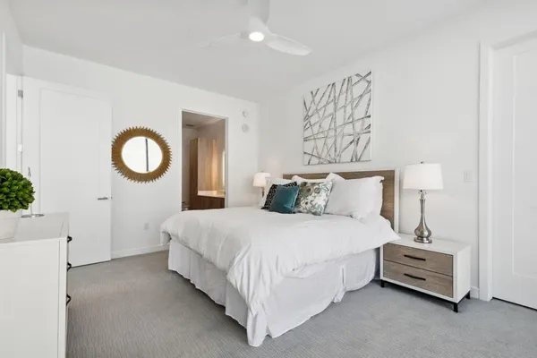 a bedroom with a bed and a night stand