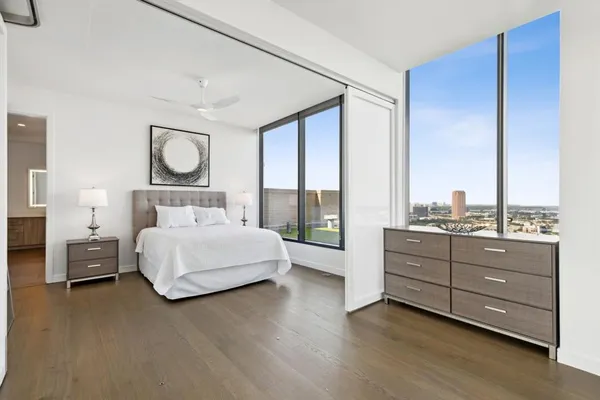 a living room with furniture and a floor to ceiling window