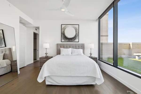 a bedroom with a large bed and large window