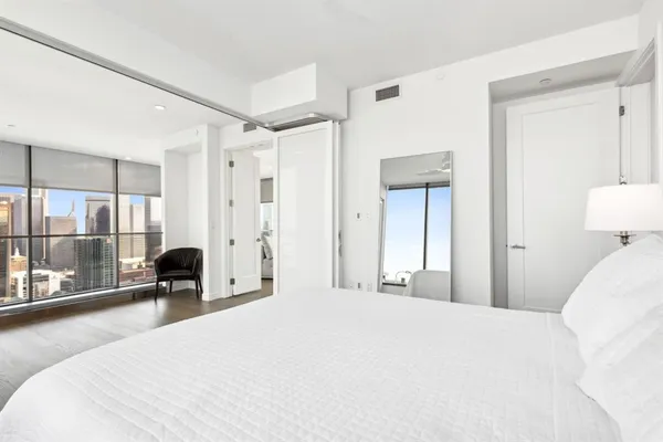 a bedroom with a bed and glass windows