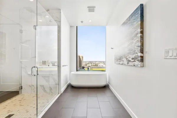 a bathroom with a tub shower and sink