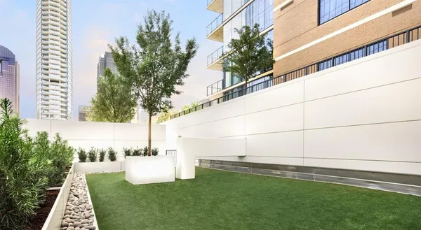 a view of a patio with couches table and chairs and potted plants