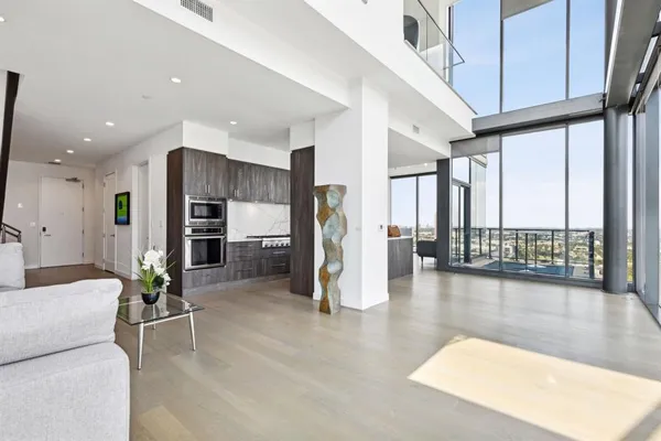 a living room with furniture gym equipment and a large window