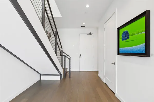 a view of an entryway with wooden floor