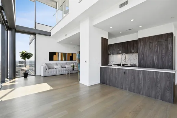 a kitchen with sink refrigerator and cabinets