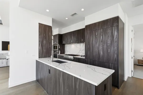 a kitchen with stainless steel appliances a sink and a refrigerator