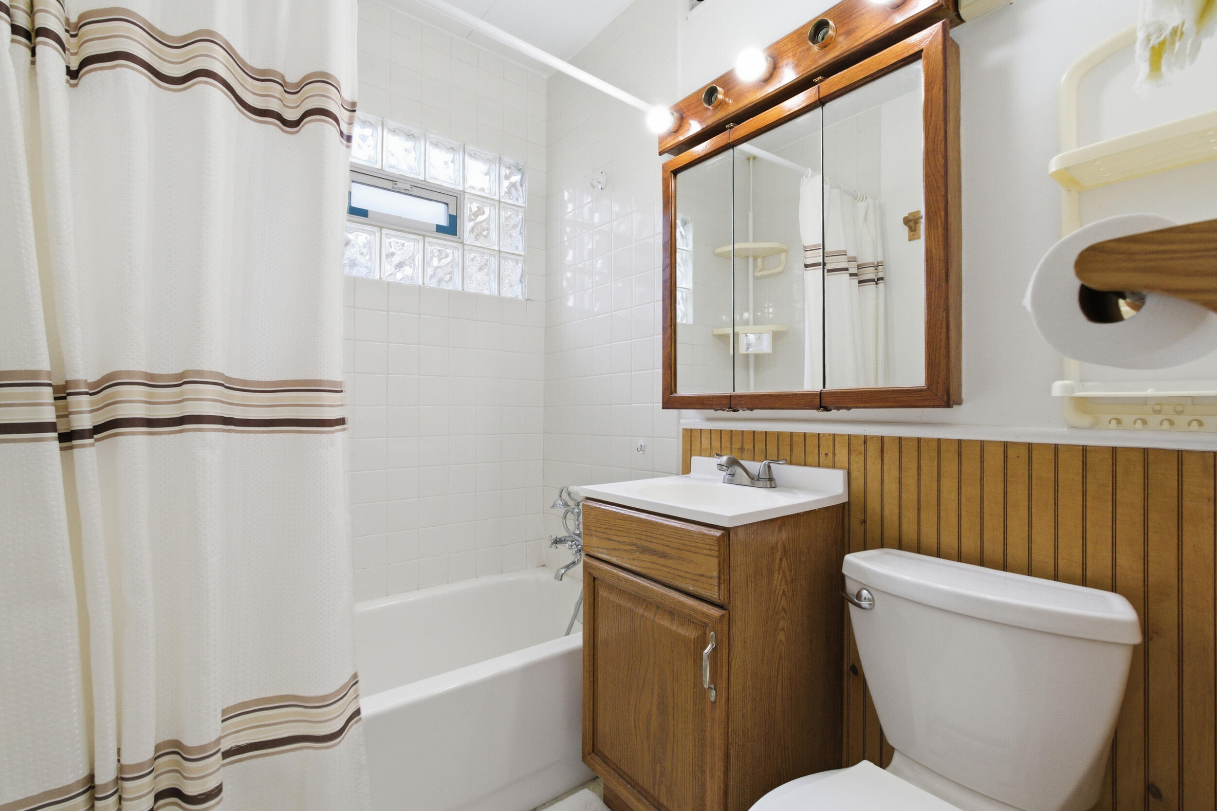 1678 174th Place Hammond, IN 46324 - Photo 14 of 18 a bathroom with a toilet sink and mirror