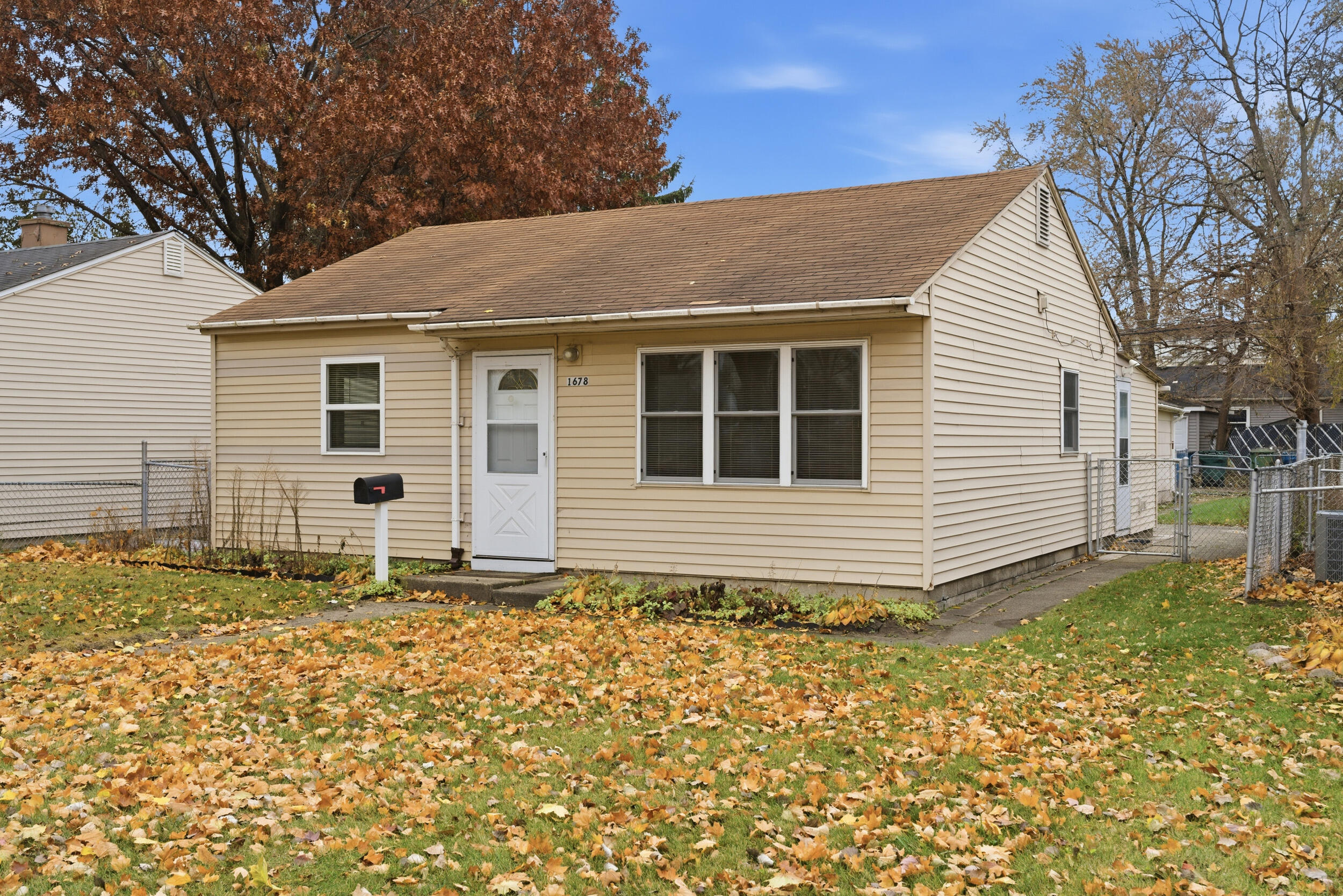 1678 174th Place Hammond, IN 46324 - Photo 2 of 18 a house with trees in the background