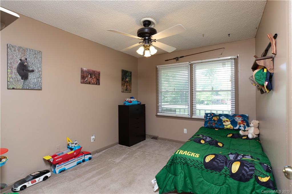 1824 Reservation Road Rock Hill, SC 29730 - Photo 3 of 24 a bedroom with a bed and a chandelier