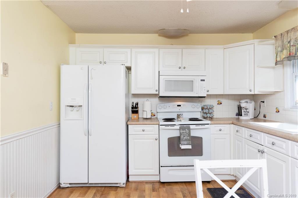 1824 Reservation Road Rock Hill, SC 29730 - Photo 22 of 24 a kitchen with stainless steel appliances granite countertop a refrigerator a sink and white cabinets