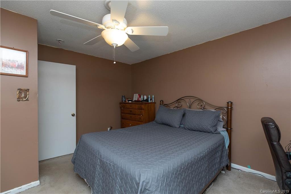 1824 Reservation Road Rock Hill, SC 29730 - Photo 8 of 24 a bedroom with a bed and a chandelier