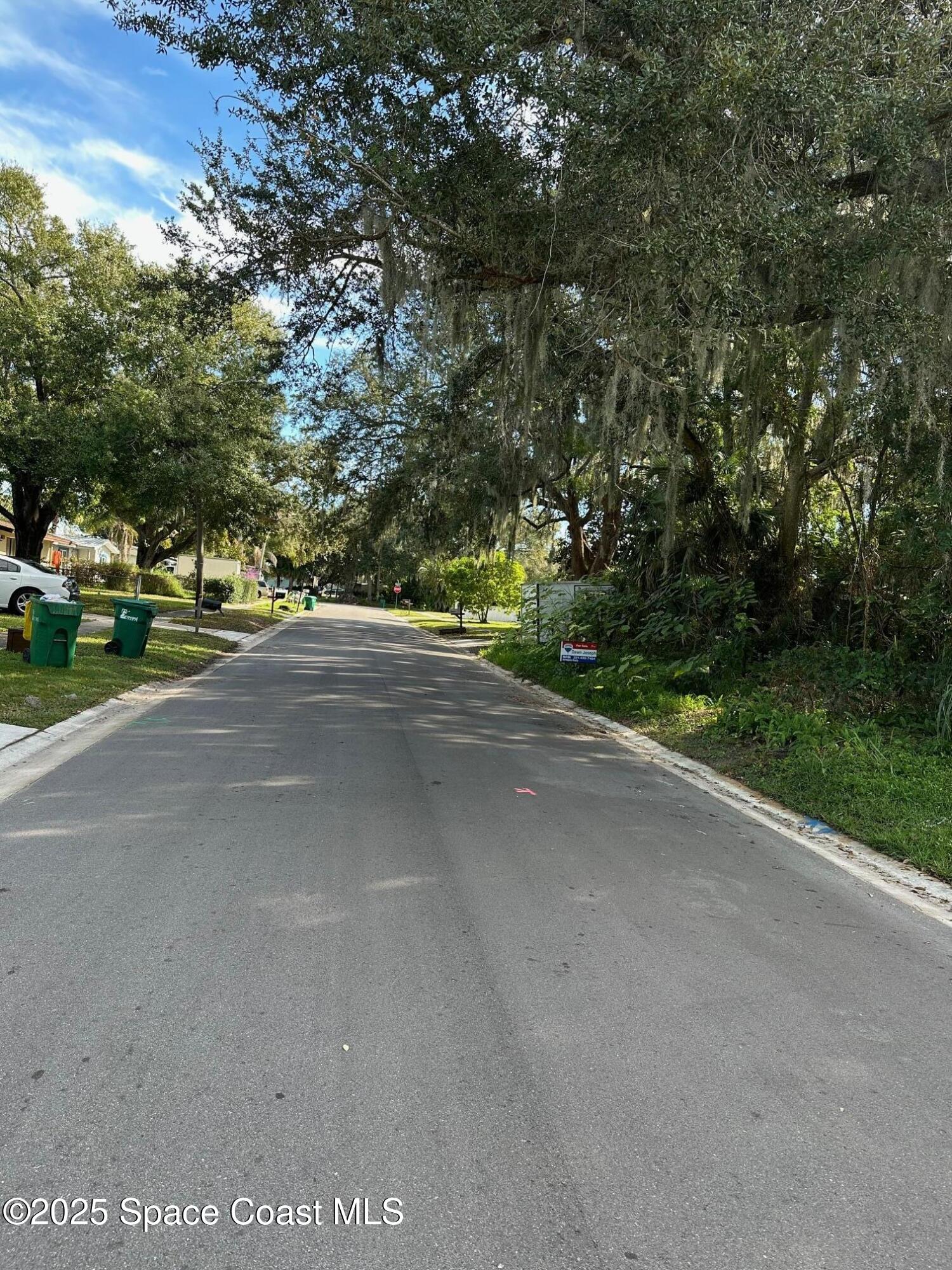2511 Hathaway Drive Cocoa, FL 32926 - Photo 2 of 3 a view of a street with a trees