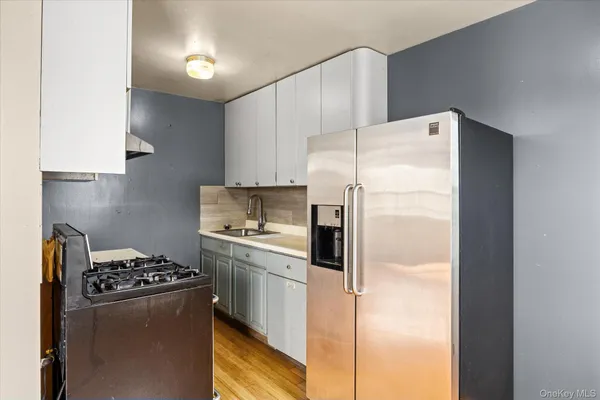 a white refrigerator freezer sitting in a kitchen
