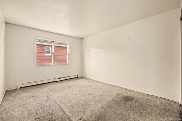 an empty room with a windows
