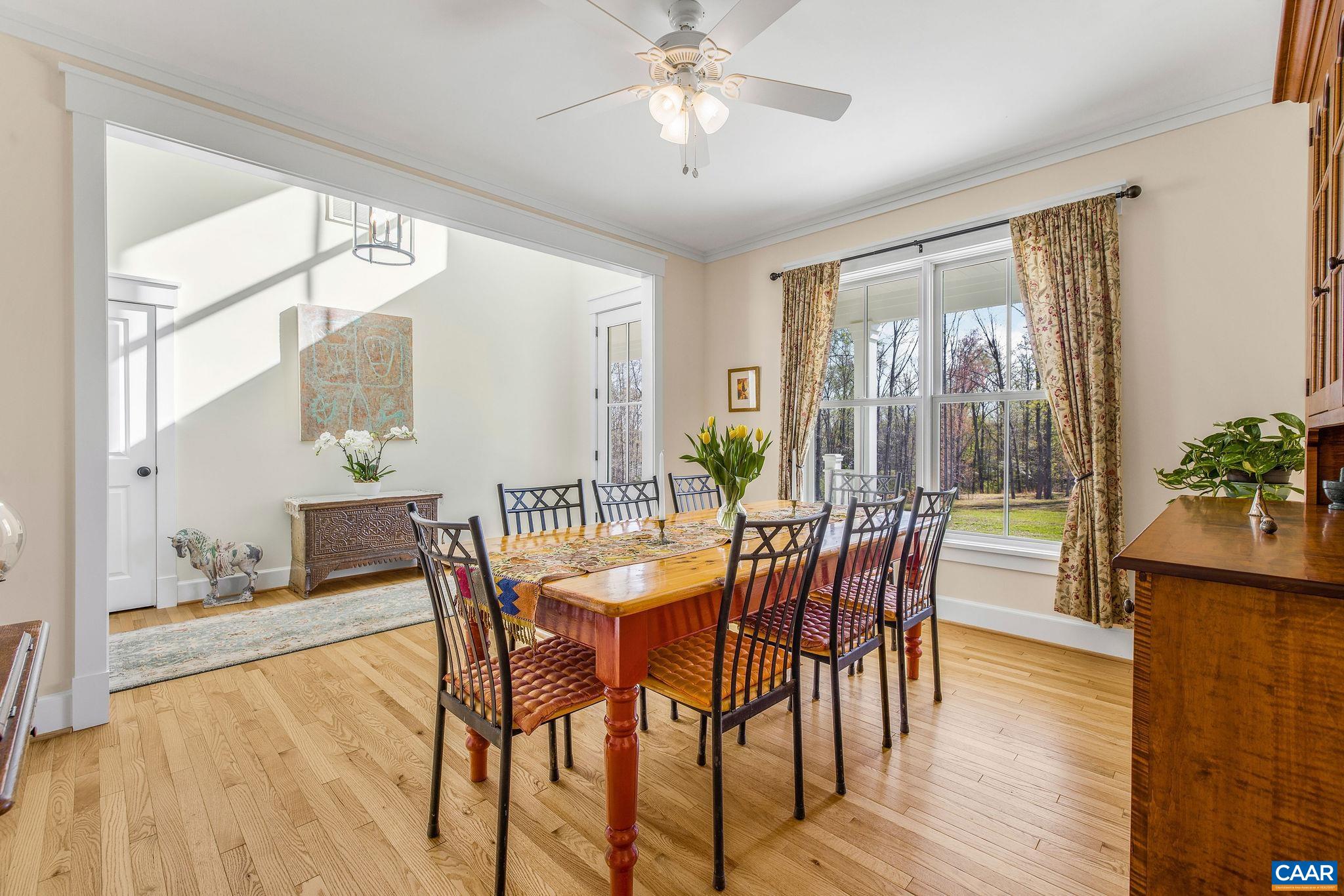 4764 Advance Mills Road Earlysville, VA 22936 - Photo 31 of 72 a dining room with furniture wooden floor and a chandelier