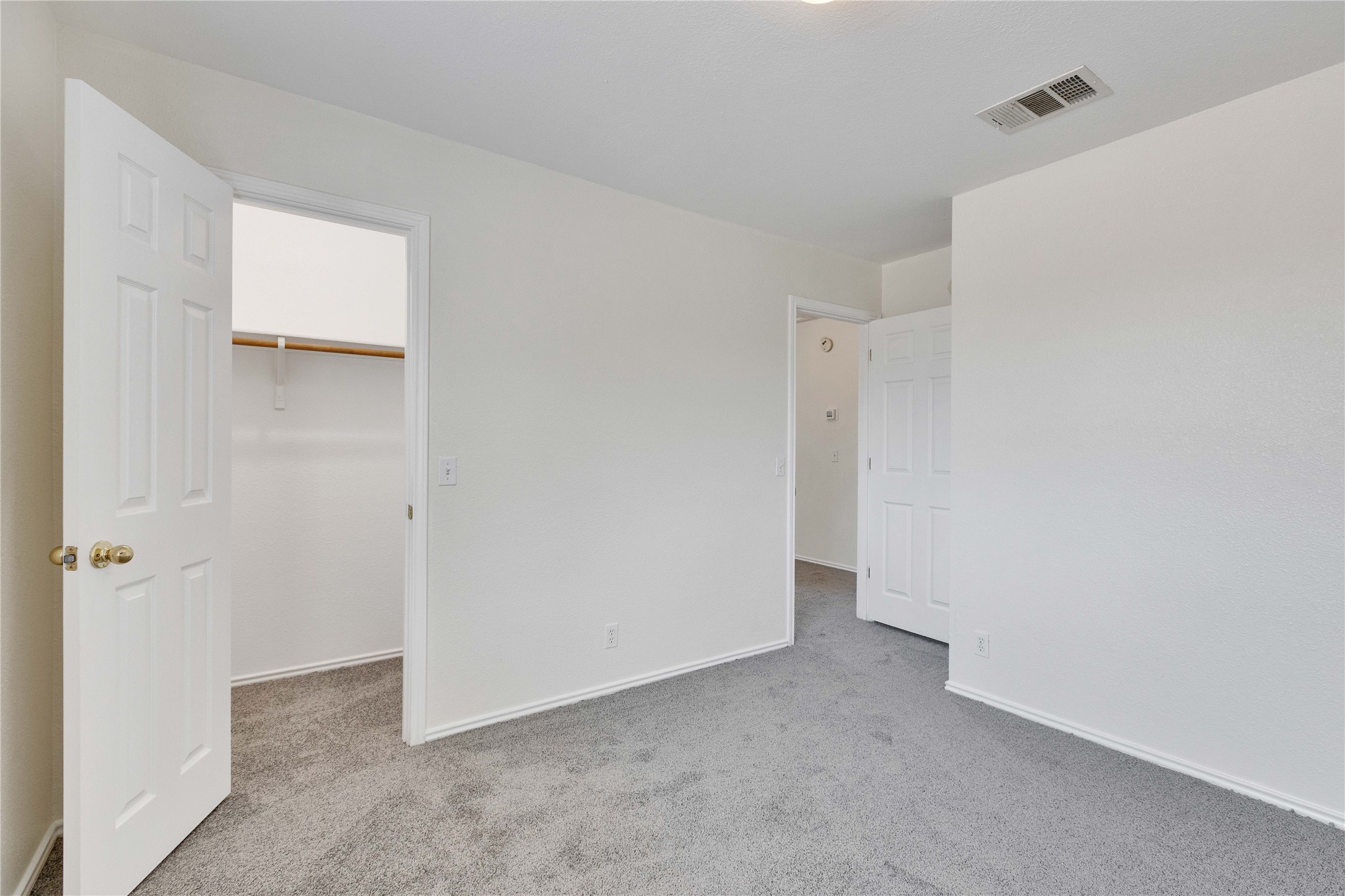14418 Pebble Run Path Manor, TX 78653 - Photo 22 of 27 A well-lit bedroom features plush carpeting and convenient closet space.
