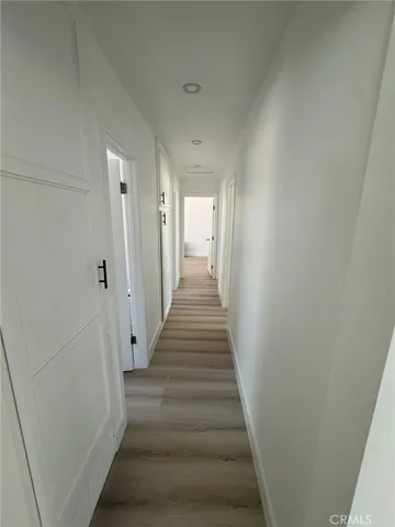 a view of a hallway with the wooden floor and entryway