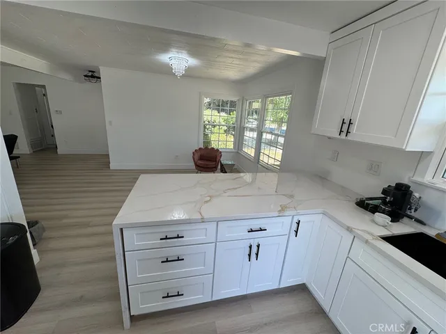 a kitchen with cabinets appliances a sink and a counter top space
