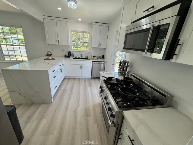 a kitchen with wooden cabinets and a stove top oven