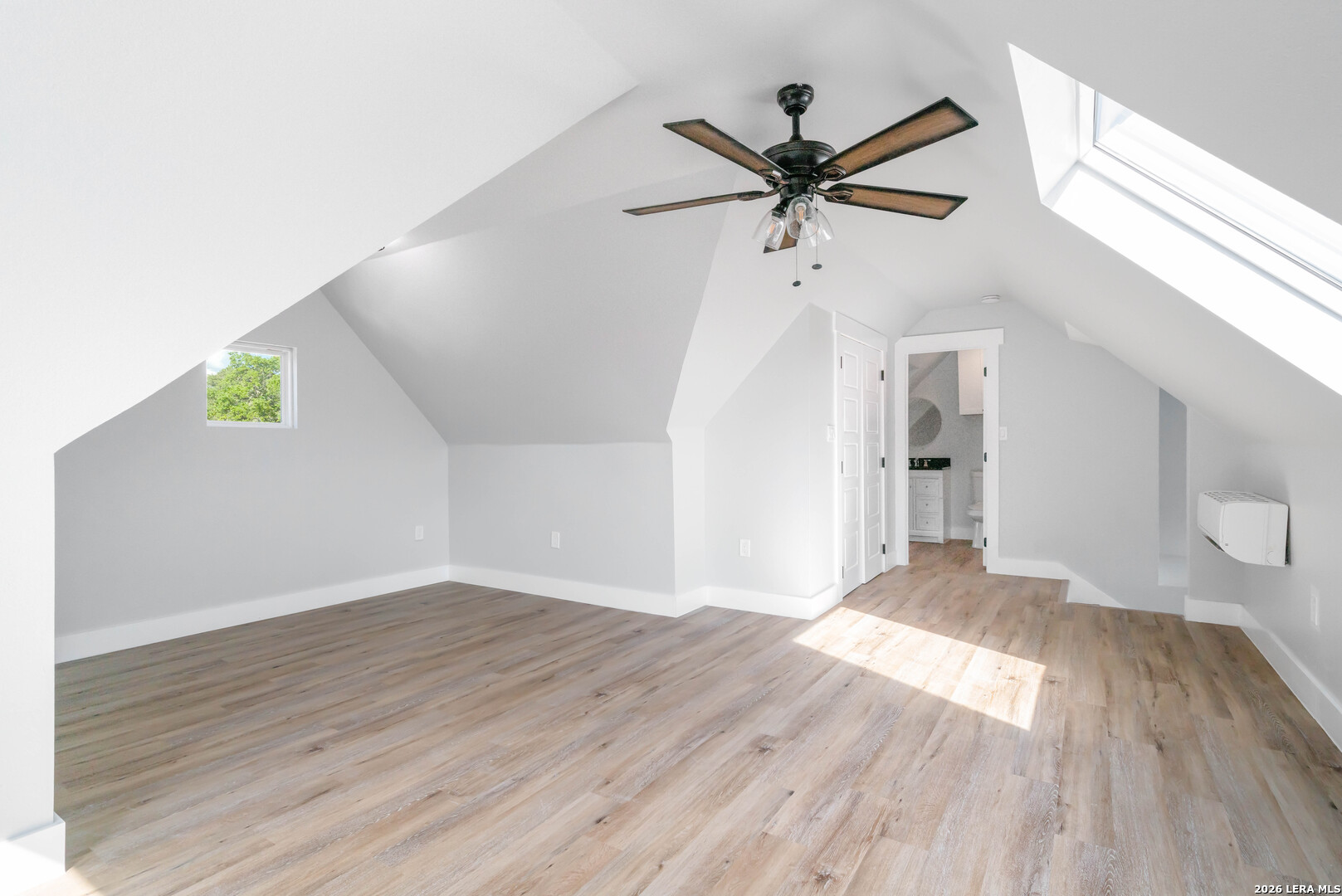11608 Oak Country Helotes, TX 78023 - Photo 16 of 19 a view of a big room with wooden floor and windows