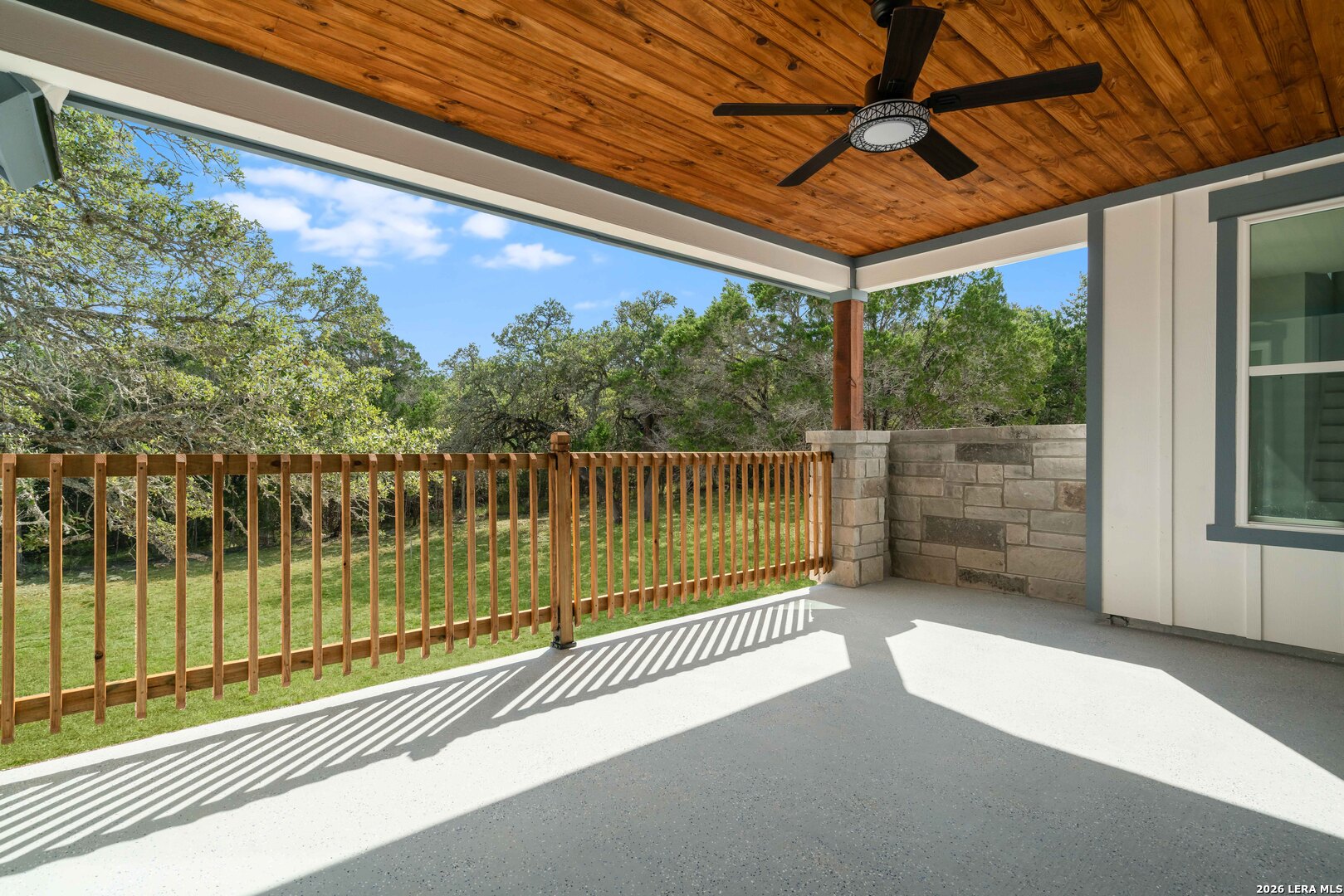 11608 Oak Country Helotes, TX 78023 - Photo 18 of 19 a view of a balcony with floor to ceiling windows with wooden floor