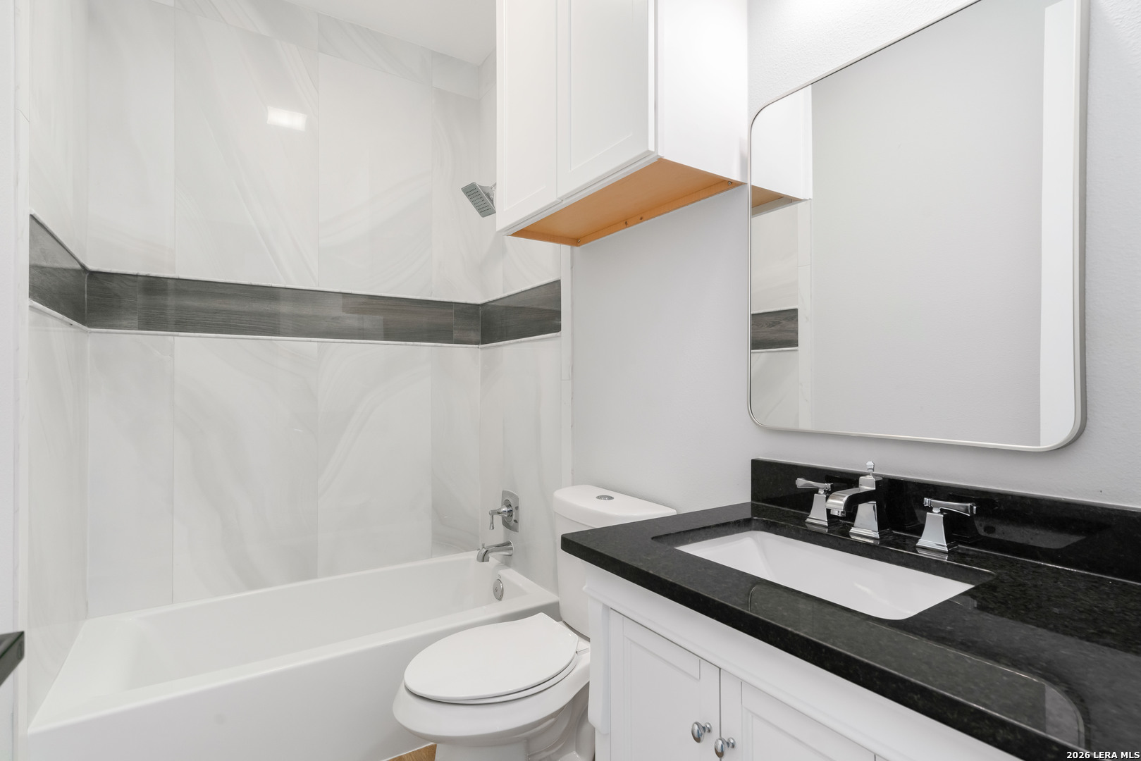 11608 Oak Country Helotes, TX 78023 - Photo 6 of 19 a bathroom with a granite countertop sink and a mirror