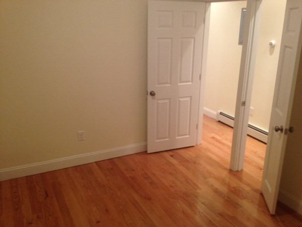 26 Maverick Street, Unit 1 Boston, MA 02128 - Photo 5 of 8 an empty room with wooden floor