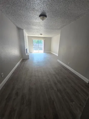 en empty room with windows and entrance