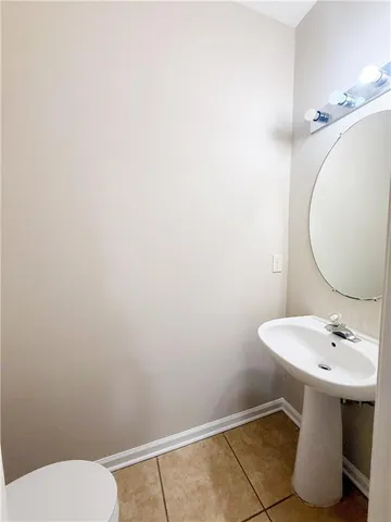 a bathroom with a sink a toilet and mirror