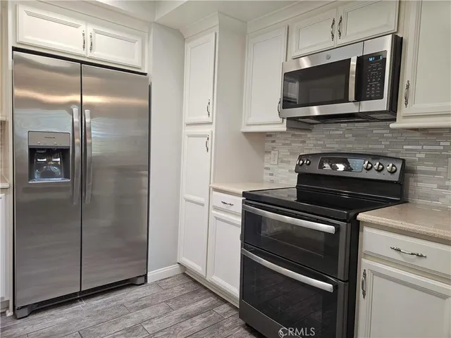 a kitchen with a refrigerator stove and microwave