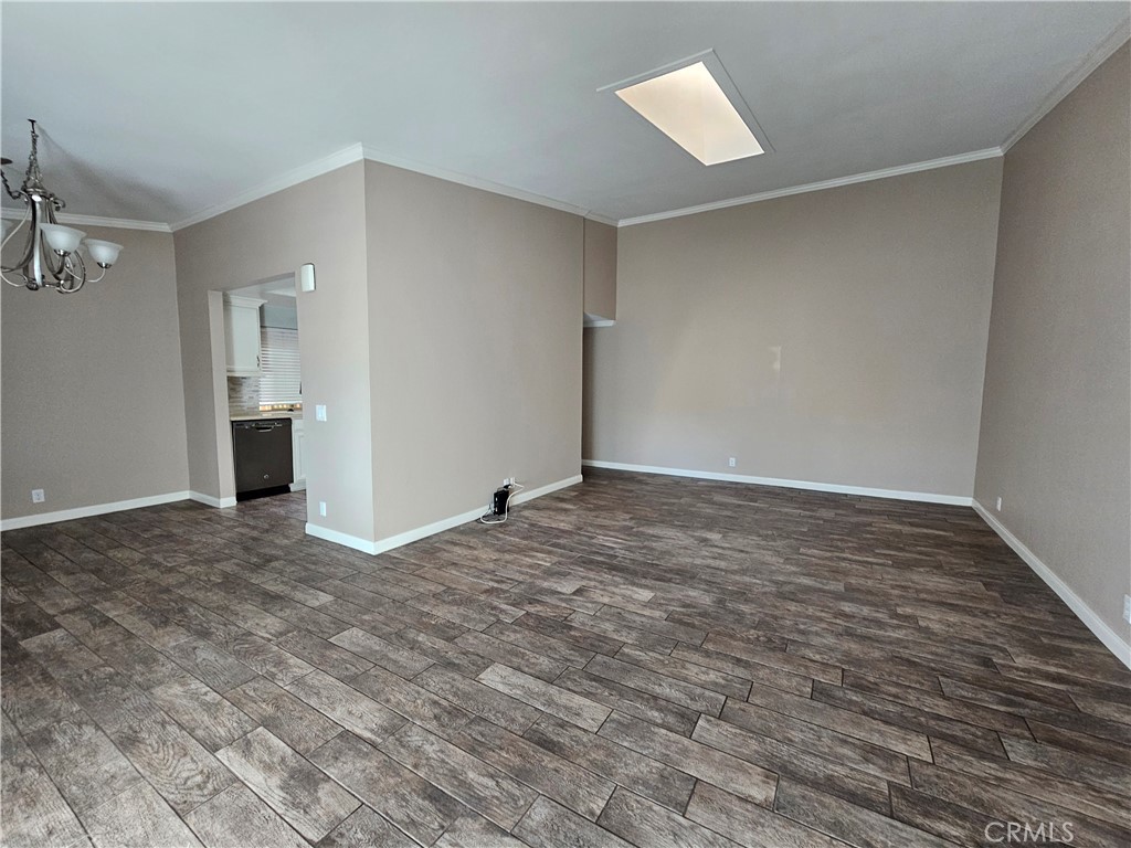 8933 Biscayne Court, Unit 221H Huntington Beach, CA 92646 - Photo 4 of 13 a view of empty room with wooden floor and fan