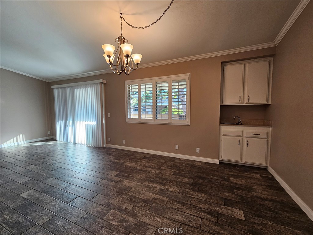 8933 Biscayne Court, Unit 221H Huntington Beach, CA 92646 - Photo 5 of 13 a view of a room with wooden floor and windows