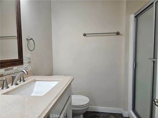 a bathroom with a sink toilet and a mirror