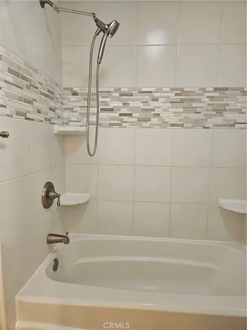 a bathroom with a bath tub and shower