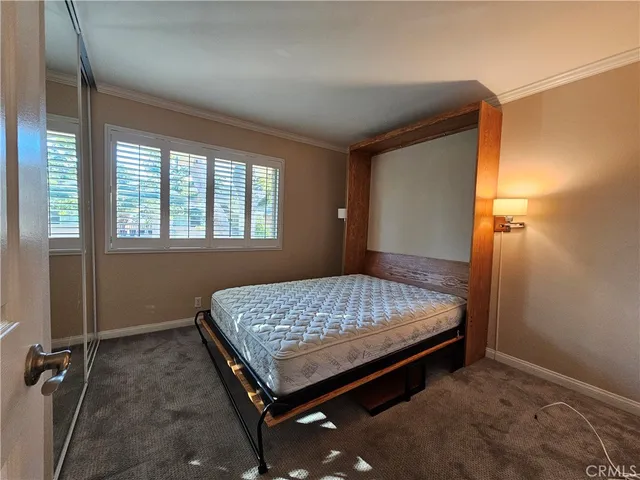 a bed sitting in a room next to a window